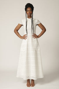 Model with braids wears a white capped-sleeve lace dress