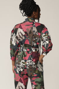 Back view of a model with braids wearing a printed boiler suit with matching belt