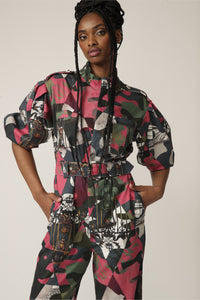 Close up of a model with braids wearing a printed boiler suit with matching belt